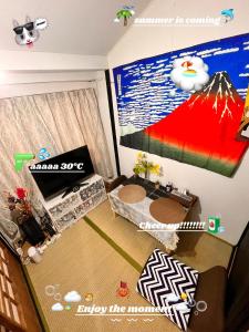 a view of a living room with a tv and a room with a room at SnowHouse in Tokyo