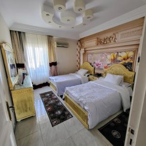 a bedroom with two beds and a painting on the wall at شقه فى ميامى بالاسكندريه مطله على البحر in Alexandria +202 photos
