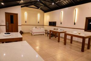 a large room with tables and a table with at Lush Acres in Thekkady