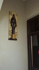 a picture of a bust of a woman on a wall at Legacy Guest Lodge in Johannesburg