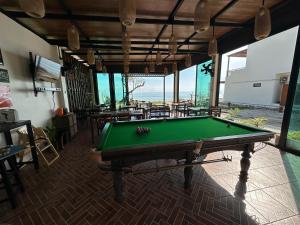 a pool table in a room with a view of the ocean at Chansi Beachresort in Tha Sala