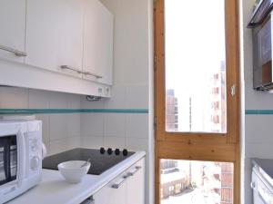 a kitchen with a sink and a microwave at Appartement fonctionnel au cœur des pistes avec balcon et accès piscine - FR-1-181-2786 in La Plagne Tarentaise