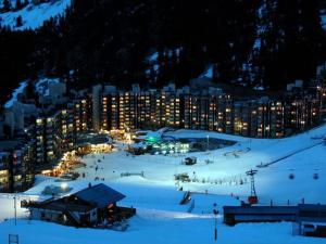 a night view of a ski resort in the snow at Appartement fonctionnel au cœur des pistes avec balcon et accès piscine - FR-1-181-2786 in La Plagne Tarentaise +6 photos
