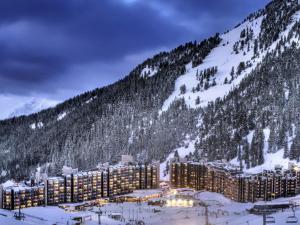 a resort in the snow in front of a mountain at Appartement fonctionnel au cœur des pistes avec balcon et accès piscine - FR-1-181-2786 in La Plagne Tarentaise