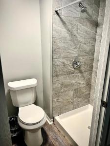 a bathroom with a toilet and a shower at Holly Oaks in Columbus
