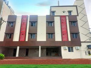 a building with red paint on the side of it at Hotel Elite Inn in Srikalahasti