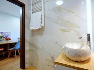 a bathroom with a large marble sink on a counter at Beautiful terraced house for 5 people, Mielenko in Mielenko