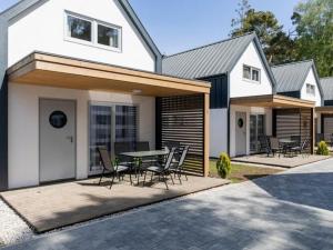 a house with a patio with a table and chairs at Cottage in Pobierowo near Baltic Beach in Pobierowo