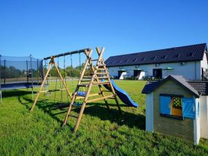 a playground with a slide and a play house at Terraced house for 5 people, Mielenko in Mielenko