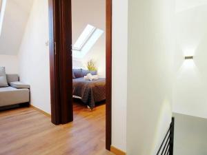 a mirror in a room with a bed and a couch at Terraced house for 4 people Mielenko in Mielenko