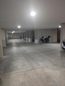 un estacionamiento vacío con una motocicleta estacionada en él en Espaço II FLAT, en Florianópolis