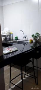 un bancone della cucina con lavandino e tavolo di Syanaz Studio Apartment a Gua Musang