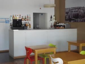 a bar with two tables and a counter at Princesa do Gilão in Tavira