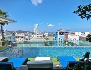 a swimming pool on the roof of a building at Sira Grande Hotel & Spa in Patong Beach