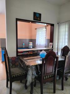 a dining room table with a large mirror on the wall at Gerards Home stay Fortkochi in Cochin