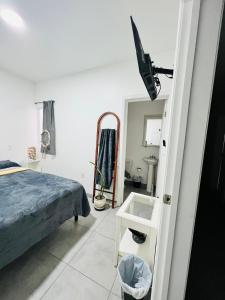 a bedroom with a bed and a flat screen tv at Casa Ambar in Tijuana