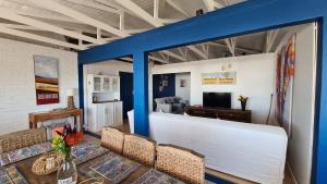 a living room with a white couch and a blue wall at Ocean Crest Villa in Cintsa Mouth West