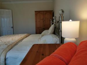 a bedroom with a bed and a table with a lamp at Castle Retreats Nest & Crown in Torquay