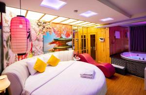 a bedroom with a large bed and a bath tub at Cupid Hotel in Ho Chi Minh City