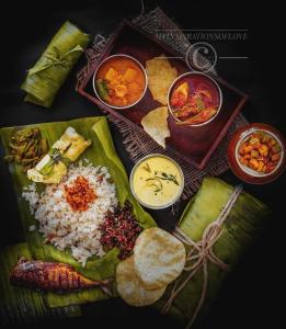 a plate of food with rice and different types of food at Dubai Hotel & Restaurant Kumarakom in Kumarakom