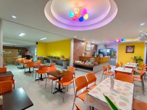 a restaurant with orange chairs and tables and a purple ceiling at Nanoplace in Ban Rai