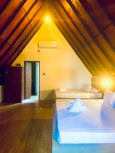 a bedroom with two beds in a attic at Deduru Cabana Nature Resort in Kurunegala