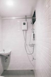 a bathroom with a shower and a sink at Jira19Hostel in Bangkok