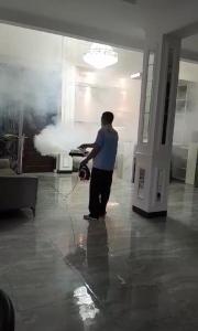 a man standing in a room with a cloud projected on the wall at Wisma Selma Garuda in Kejayan