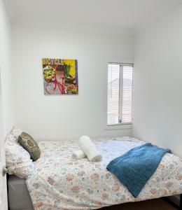 a bedroom with a bed with a poster on the wall at House on Hamilton-No Party/Event in Fairfield