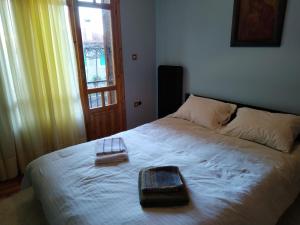 a bedroom with a bed with two towels on it at Darwin Primula in Konitsa
