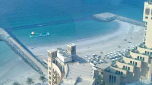 an aerial view of the beach and buildings at FT22 R3 Open beach ajman washroom is outside in Ajman 
