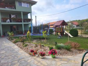 a yard with a playground and a house at Apartment Pavlovic in Soko Banja