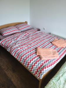 a bed with two towels on top of it at Apartment Pavlovic in Soko Banja