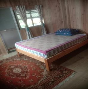 a bed sitting on top of a rug in a room at Sungava Homestay by StayApart in Sonāda