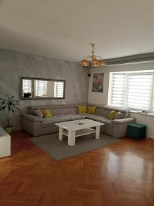 a living room with a couch and a table at ROYAL Apartmani in Bosanski Šamac