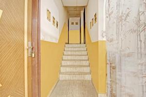 een trap in een gebouw met gele muren bij OYO The Premium Villa Near Lotus Temple in New Delhi