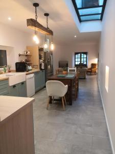 a kitchen and living room with a table and chairs at Gites Mendiburia in Iholdy