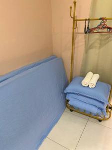 a room with a bed with two towels on it at Jovial Modern&Stylish `UrbanSuites in Jelutong