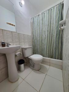 a bathroom with a toilet and a sink and a shower at Cusco Plaza de Armas in Cusco