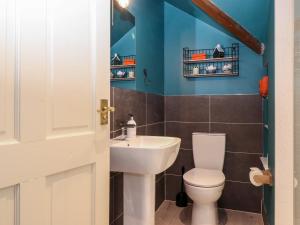 a bathroom with a toilet and a sink at Peony Cottage in Ulverston +17 photos