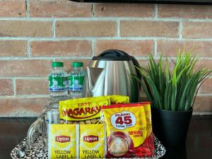 a tray with some food and drinks on a counter at Lee Boutique Hotel Baguio in Baguio