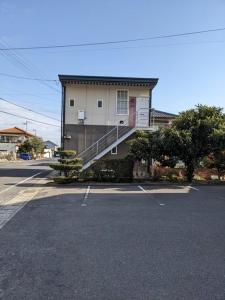 a building with a staircase on the side of a parking lot at marugame stop - Vacation STAY 86888v in Marugame