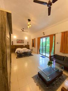 a living room with a couch and a bed at 4bhk cabin in the woods- Lonavala in Lonavala