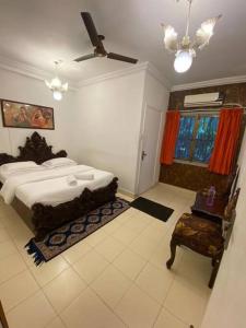 a bedroom with a large bed and a window at 4bhk cabin in the woods- Lonavala in Lonavala