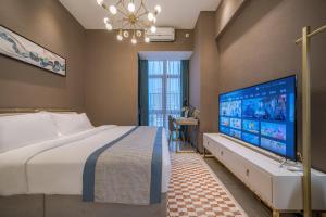 Postel nebo postele na pokoji v ubytování Gepai Executive Apartment - Shenzhen Futian Convention and Exhibition Center