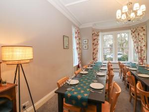 a dining room with a long table and chairs at Fern Lee in Carlisle