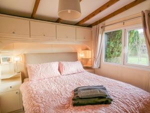 a bedroom with a large bed and a window at Riverside Rest in Builth Wells