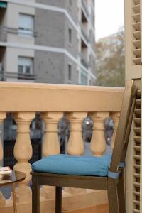a chair sitting on a balcony with a window at Cal Mateu 11 huéspedes Sagrada Família in Barcelona