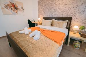 a bedroom with a bed with two towels on it at Plaza View in Bucharest