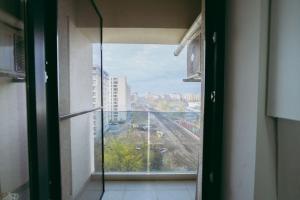 a room with a window with a view of a city at Plaza View in Bucharest